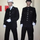 Photo:Two Brighton Police uniforms. On the right a "dog collar" uniform (pre 1953) - on the left - an open collar uniform (post 1953)