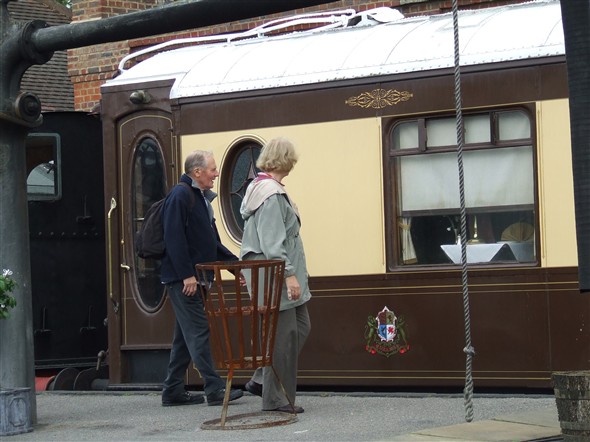Photo:Bob and Betty admiring one of the Pullman coaches which are used on occasion for lunches and dinners