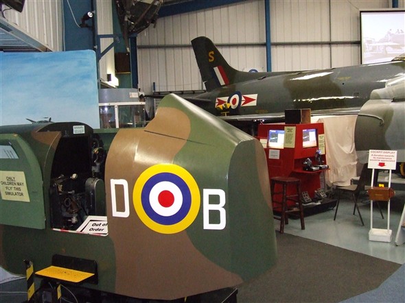 Photo:Two simulators shown here. The one in the foreground is an early type whilst the red one in the background is for those visitors who wish to practice their flying skills