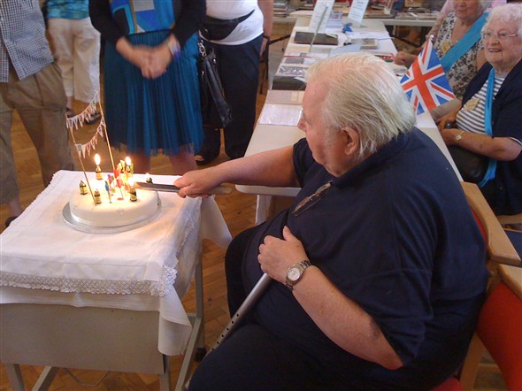 Photo:Fred Netley cutting our anniversary cake.
